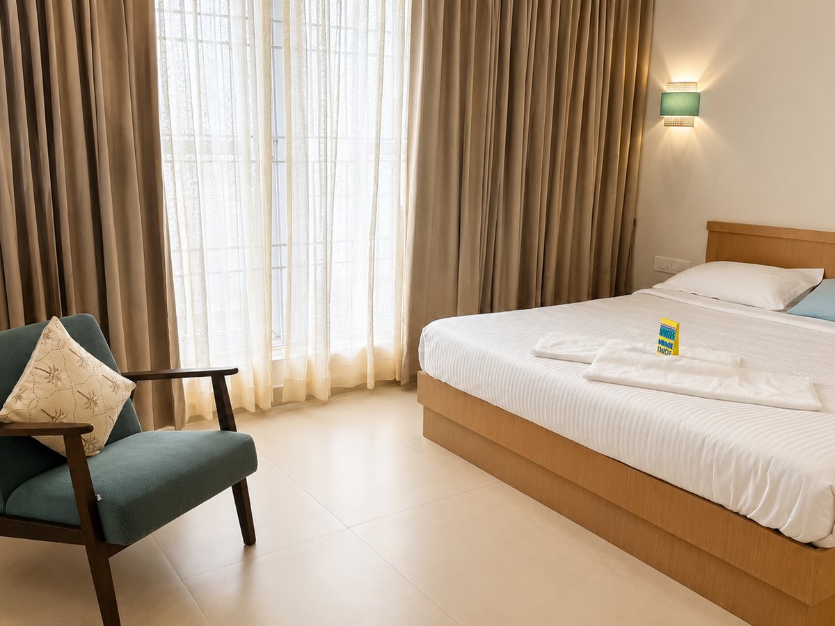 Bedroom with reading chair at RYST 109A beach villa, Pearl Beach, Cheyyur