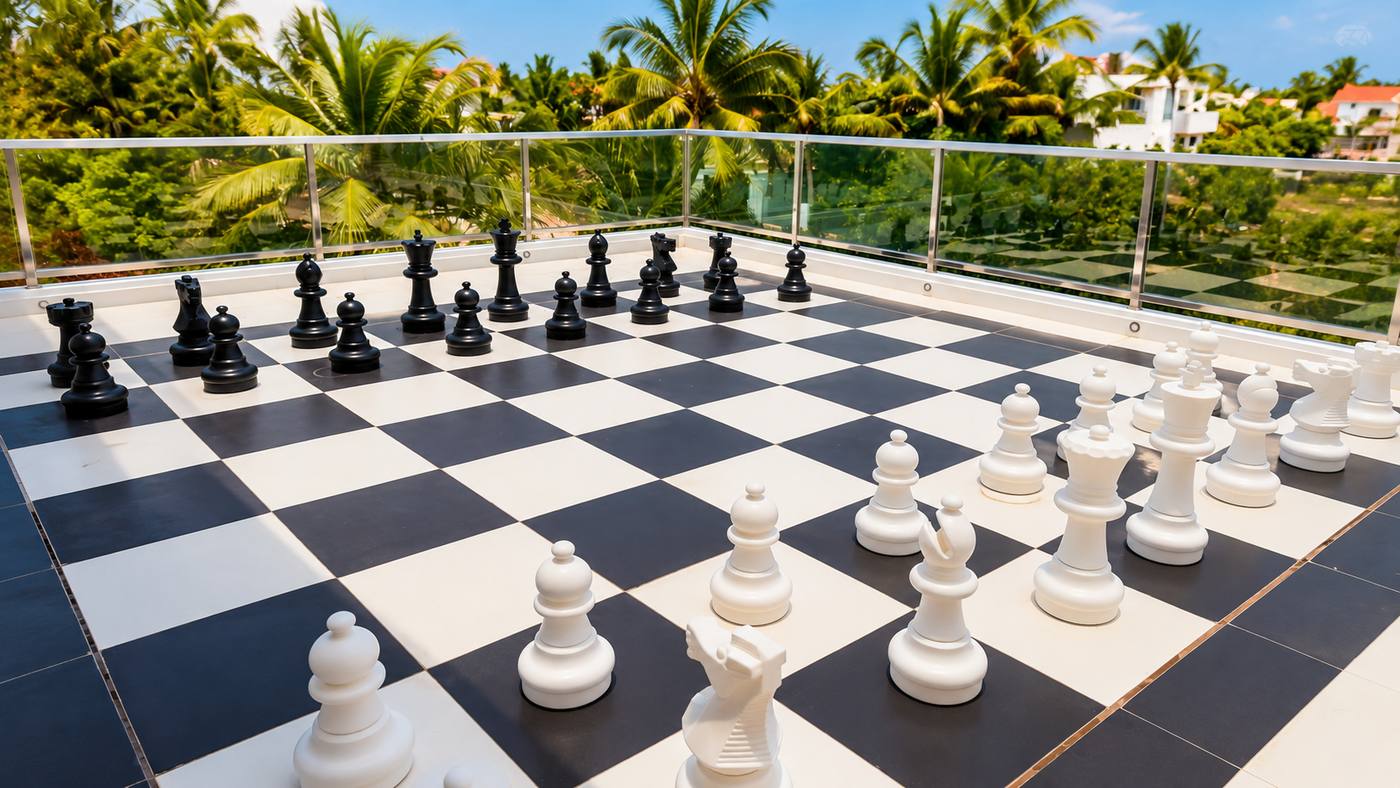 Life-size chess board on the balcony at RYST 109A, overlooking the palms, Pearl Beach, Cheyyur