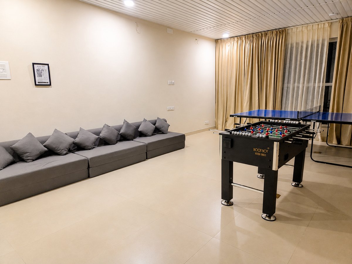 Recreation hall with long lounge seating, foosball and table tennis at RYST 109A, Pearl Beach, Cheyyur