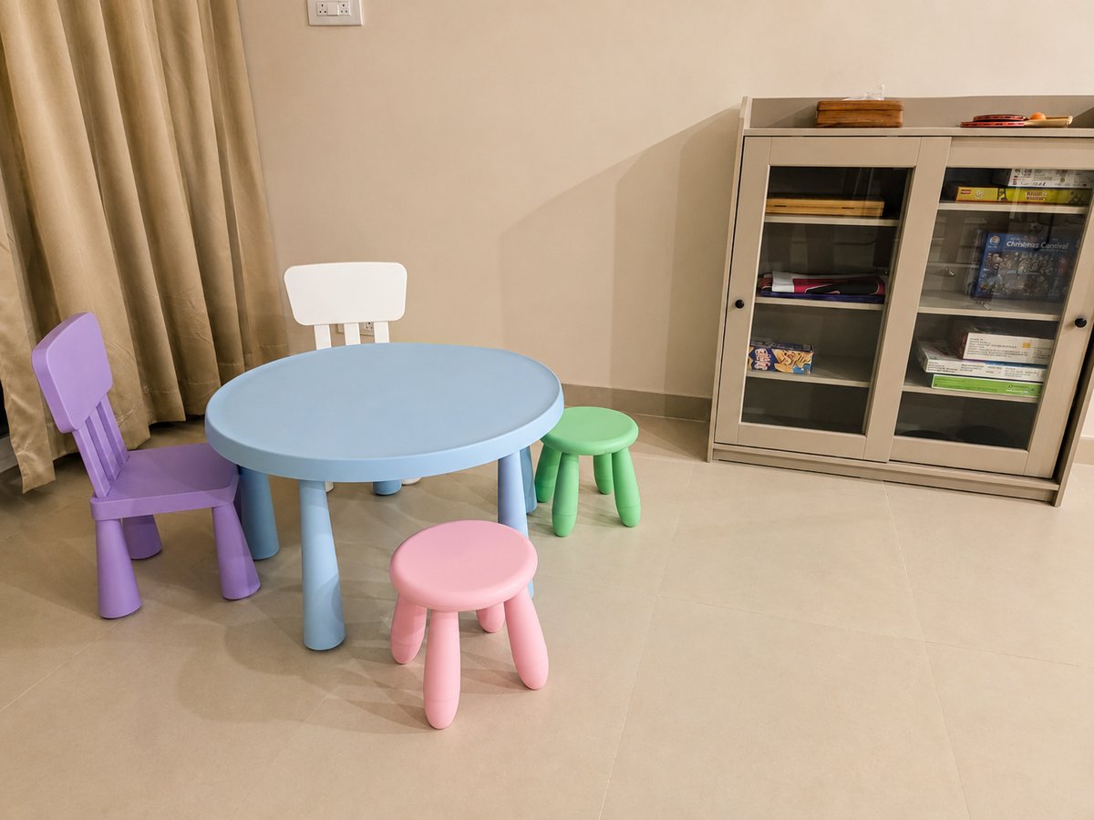 Kids' play corner with a table, chairs and board games cabinet at RYST 109A, Pearl Beach, Cheyyur