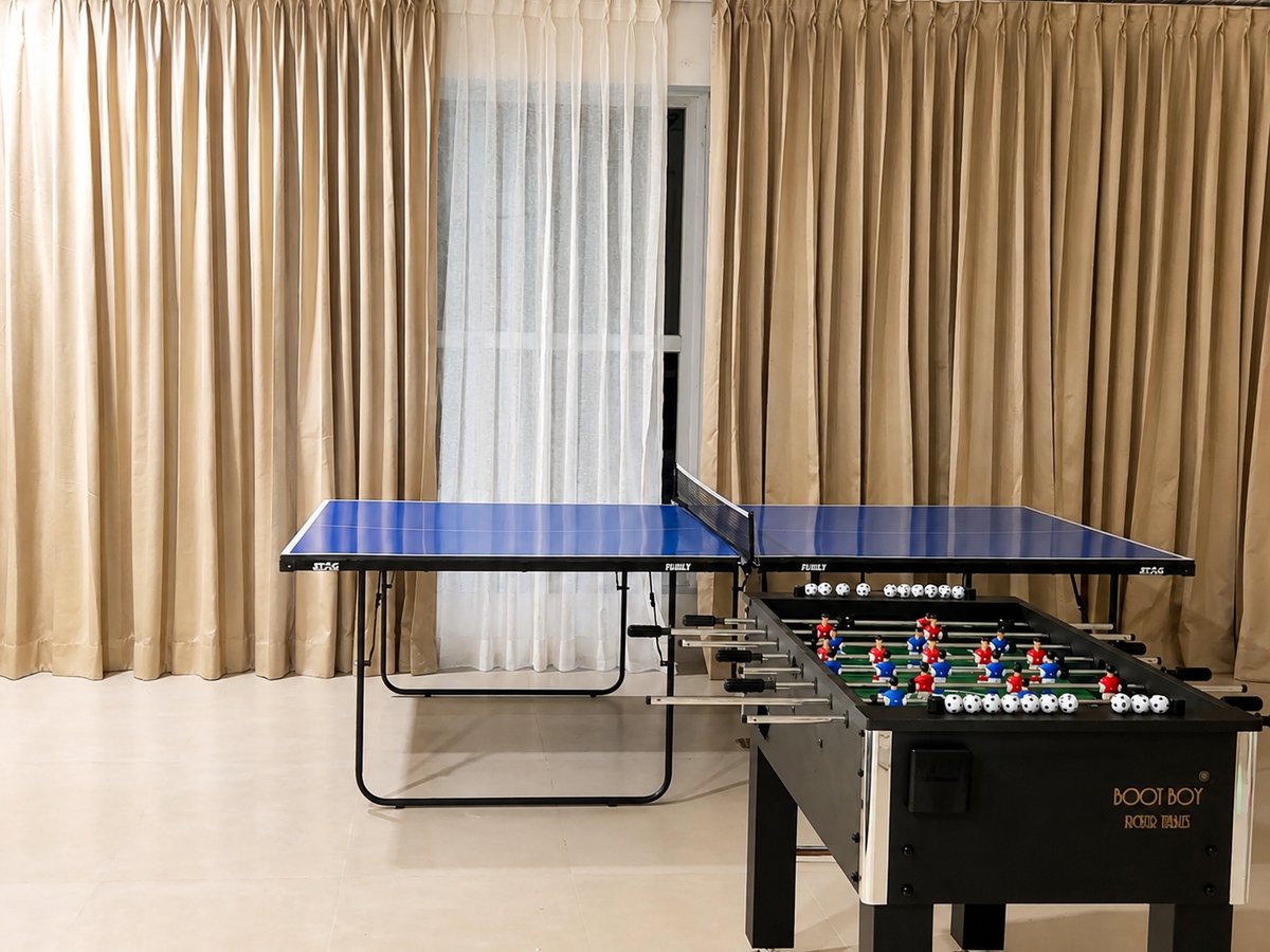 Table tennis and foosball tables side by side at RYST 109A, Pearl Beach, Cheyyur