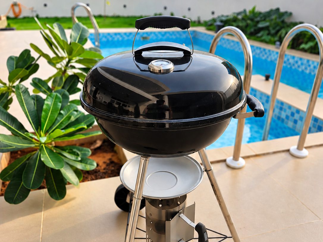 Charcoal kettle barbecue grill on the pool deck at RYST 109A beach villa, Pearl Beach, Cheyyur