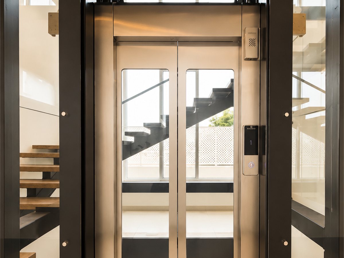 Glass-enclosed elevator and floating staircase at RYST 109A, Pearl Beach, Cheyyur